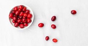 Cranberries in a bowl on a light cloth